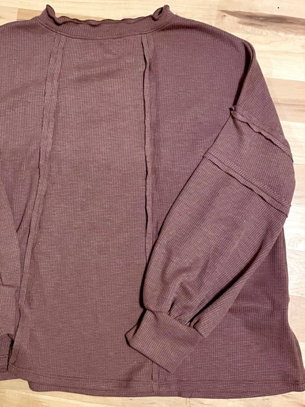 NWOT brown knit top with cute exposed-seam details.